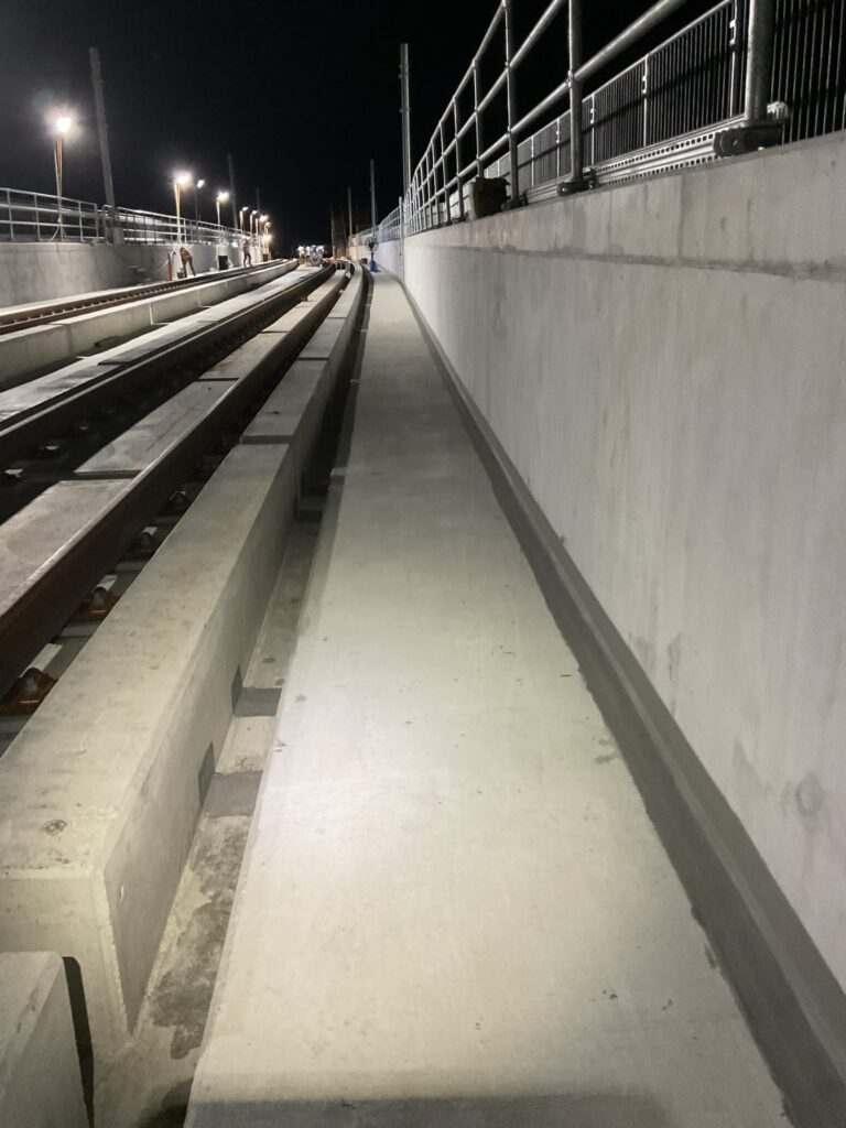 Completed joint waterproofing along the Byford rail extension track at night