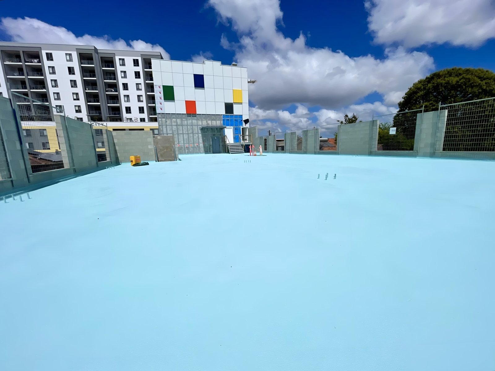 Waterproofing work across an external podium deck