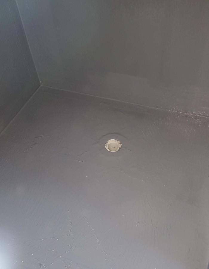 Waterproofing membrane detailed around a shower floor waste